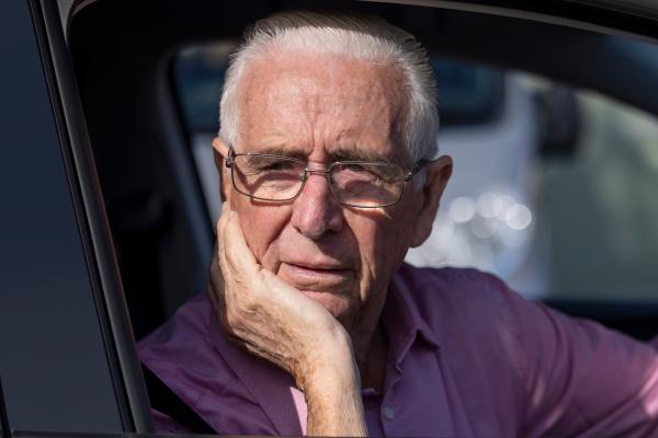 Older man driving and confused