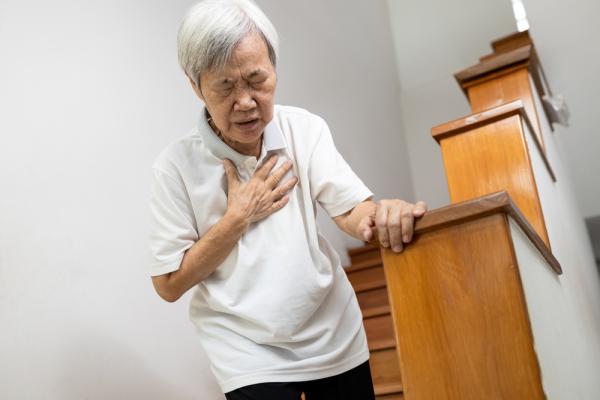 Asian woman clutching chest