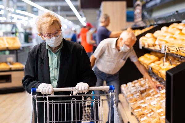 Older couple shopping with masks on