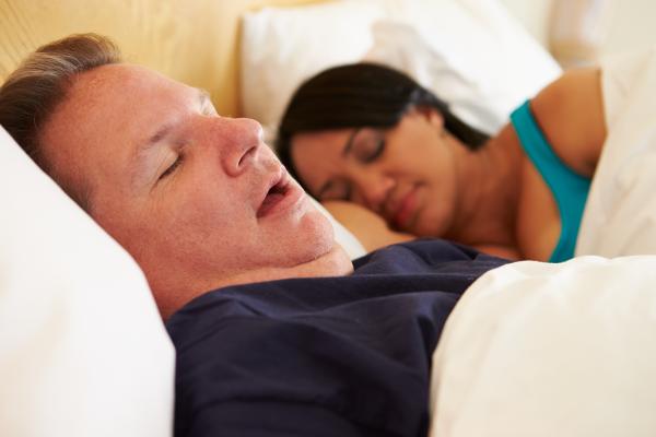 couple asleep on the bed, man snoring
