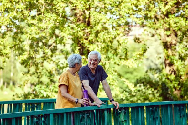 Older couple on a bridge in a park