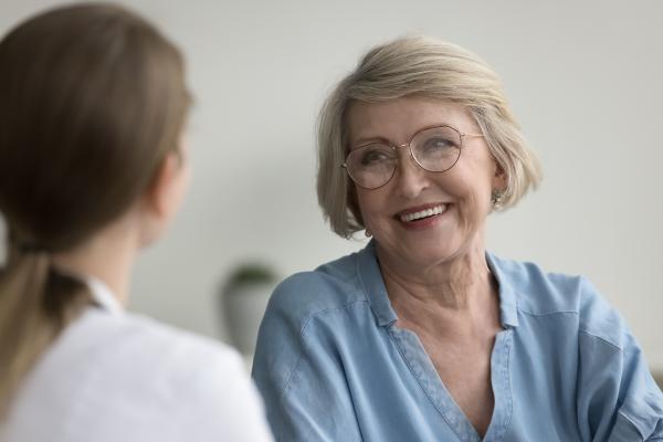 Older female patient talking to doctor