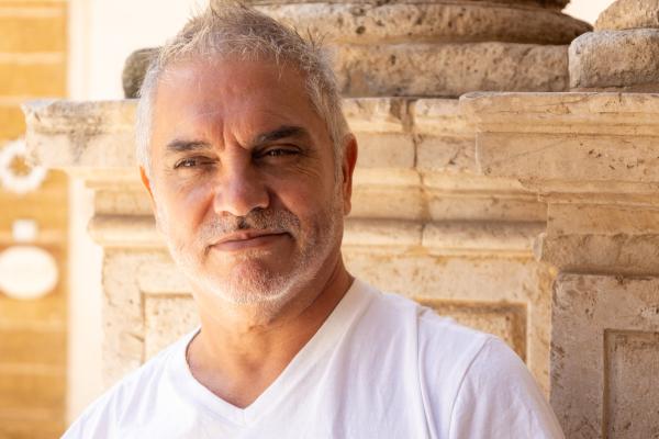 headshot of an old man in white shirt