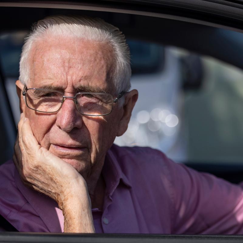 Older man driving and confused