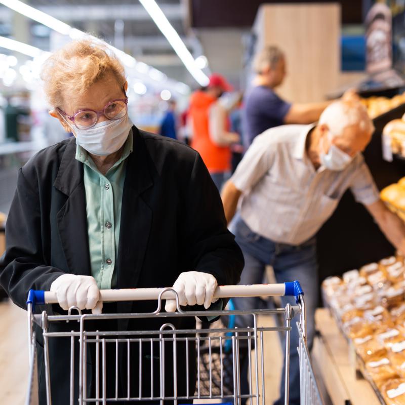 Older couple shopping with masks on