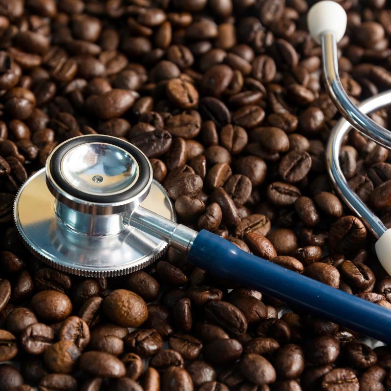 stock-photo-coffee-beans-and-stethoscope-in-concept-health-of-coffee-drinkers-quality-of-coffee