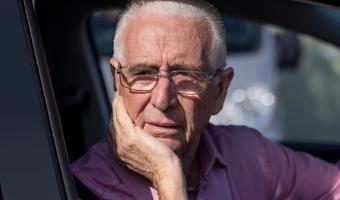 Older man driving and confused