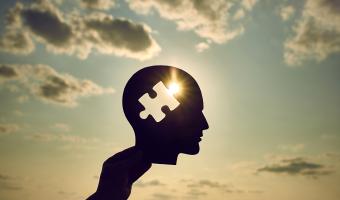 Concept of a human head with a puzzle in the middle