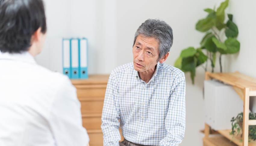 Frail asian man in medical consultation with GP