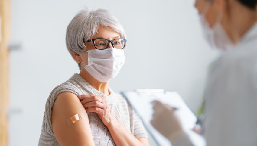 Patient with mask on being vaccinated