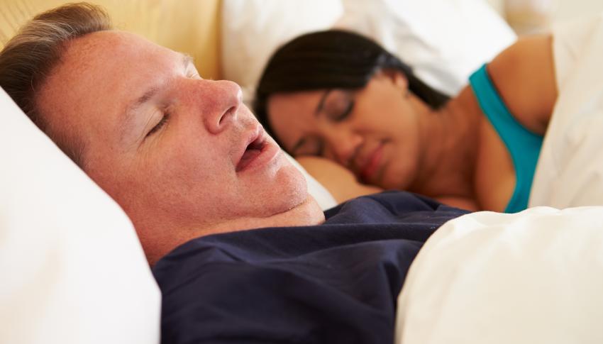 couple asleep on the bed, man snoring
