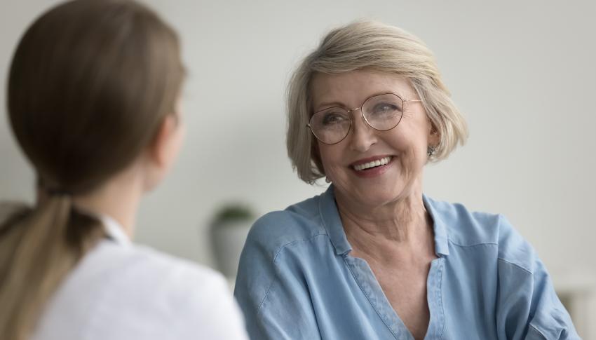 Older female patient talking to doctor