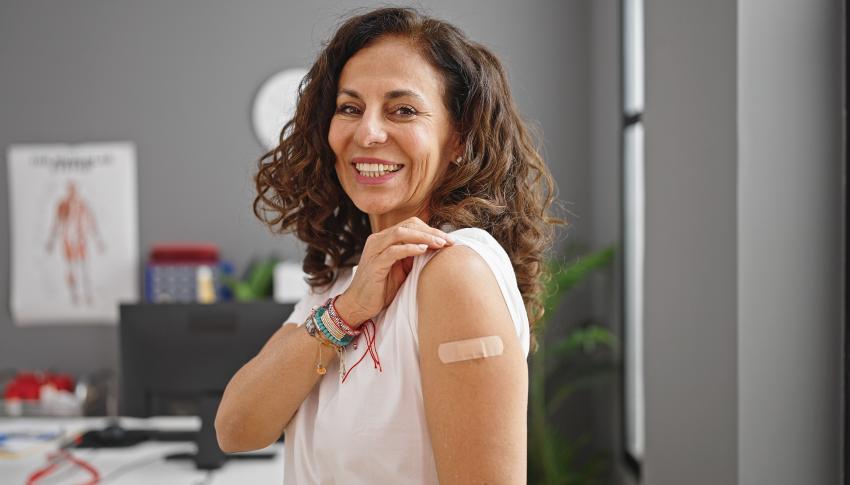 Middle aged women proudly showing the site of her herpes zoster vaccination