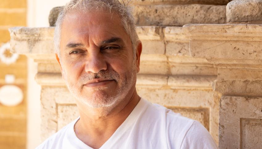 headshot of an old man in white shirt