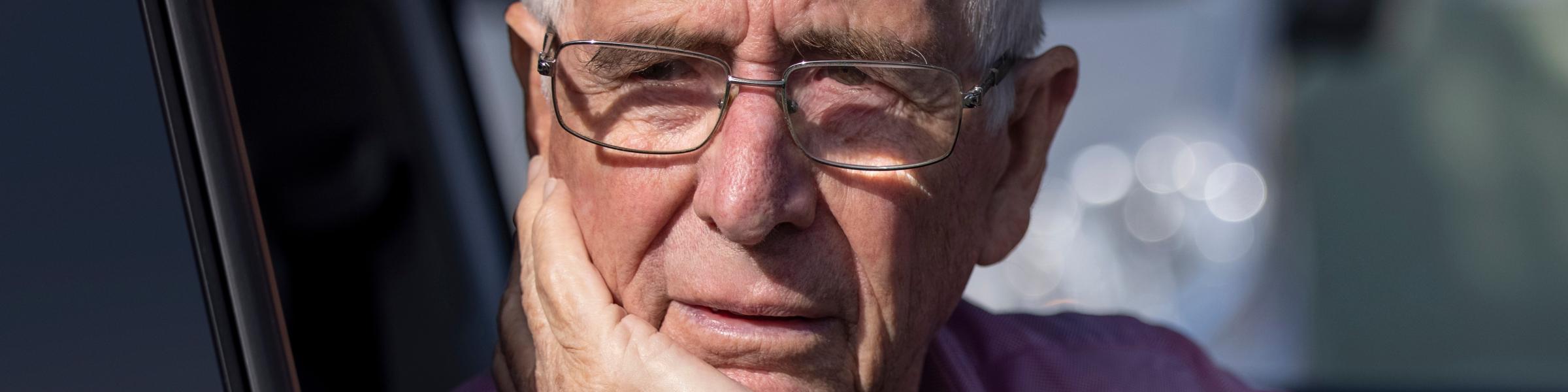 Older man driving and confused