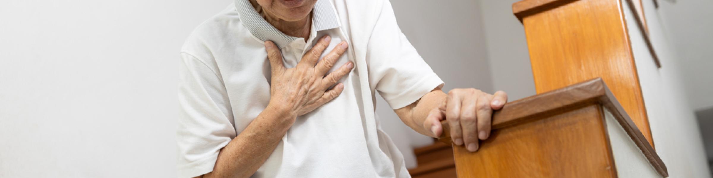 Asian woman clutching chest