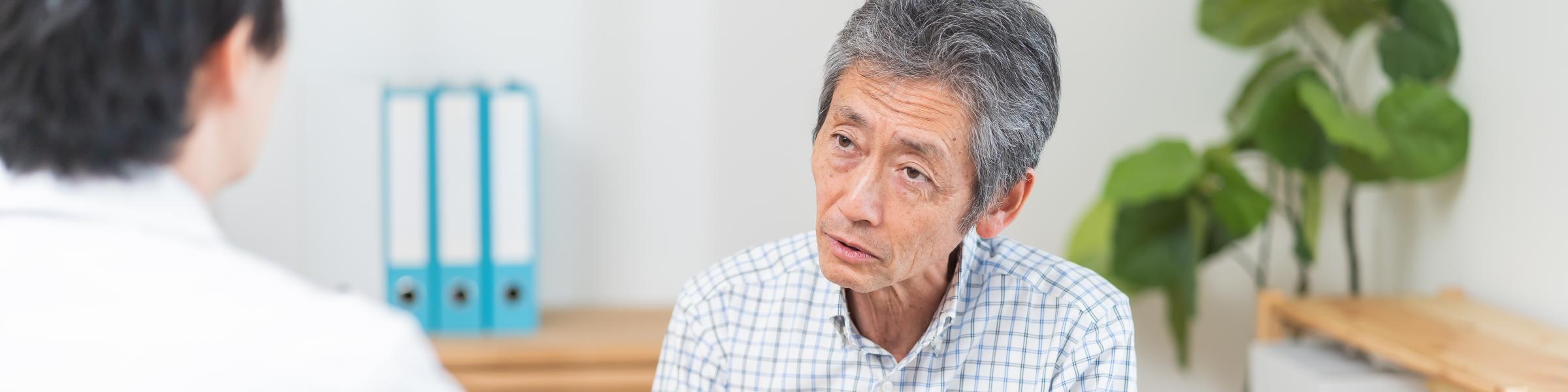 Frail asian man in medical consultation with GP
