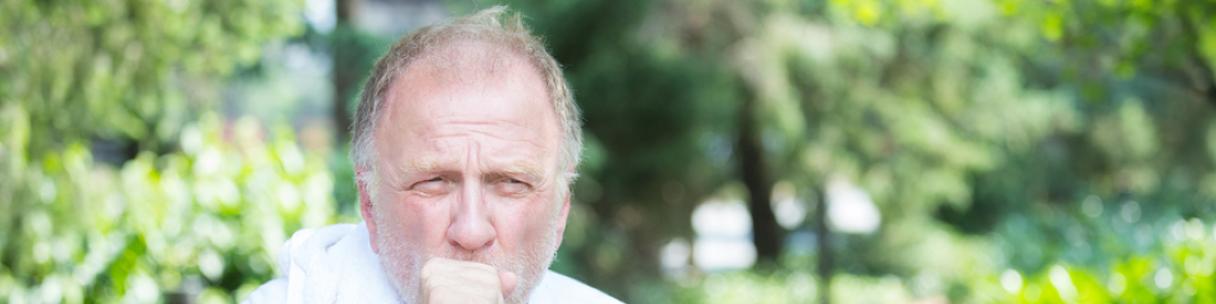 Older man coughing