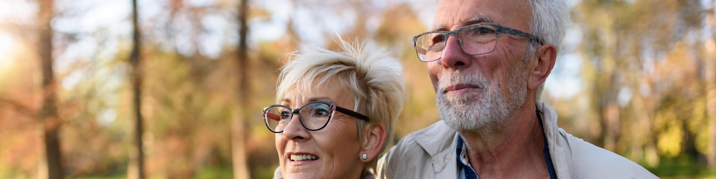 Older couple outside and smiling because they have their RSV vaccine