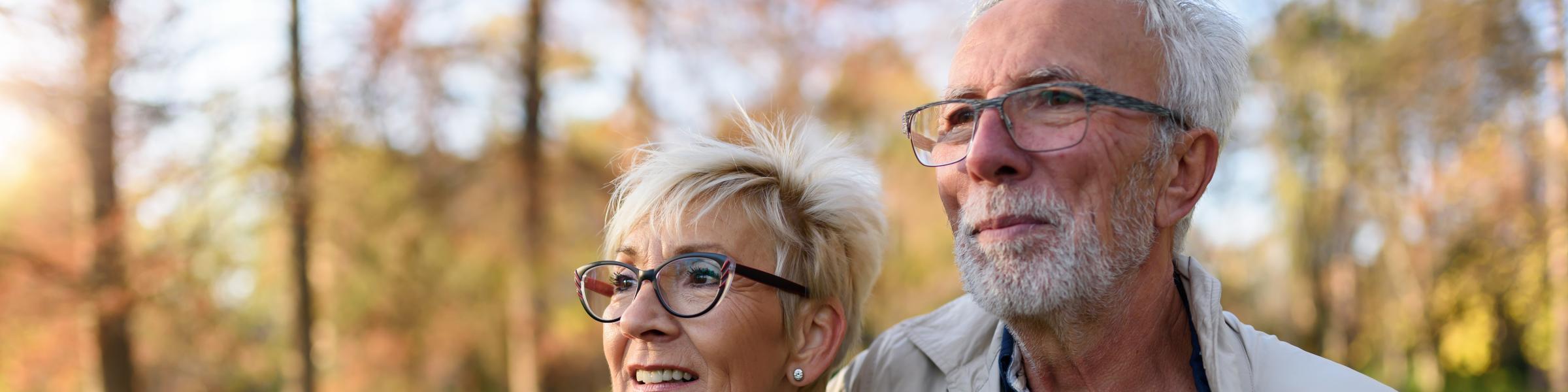 Older couple outside and smiling because they have their RSV vaccine