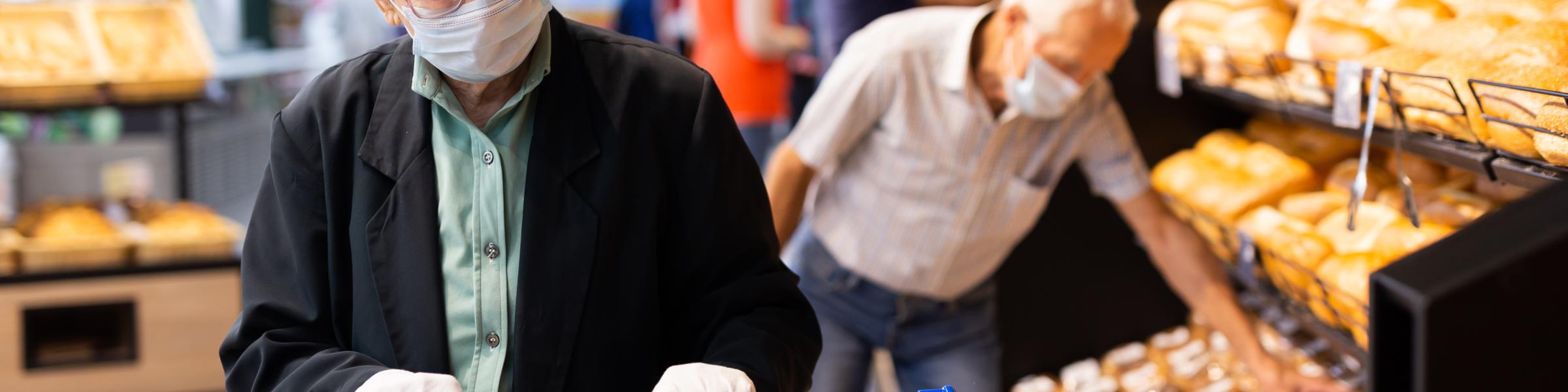 Older couple shopping with masks on