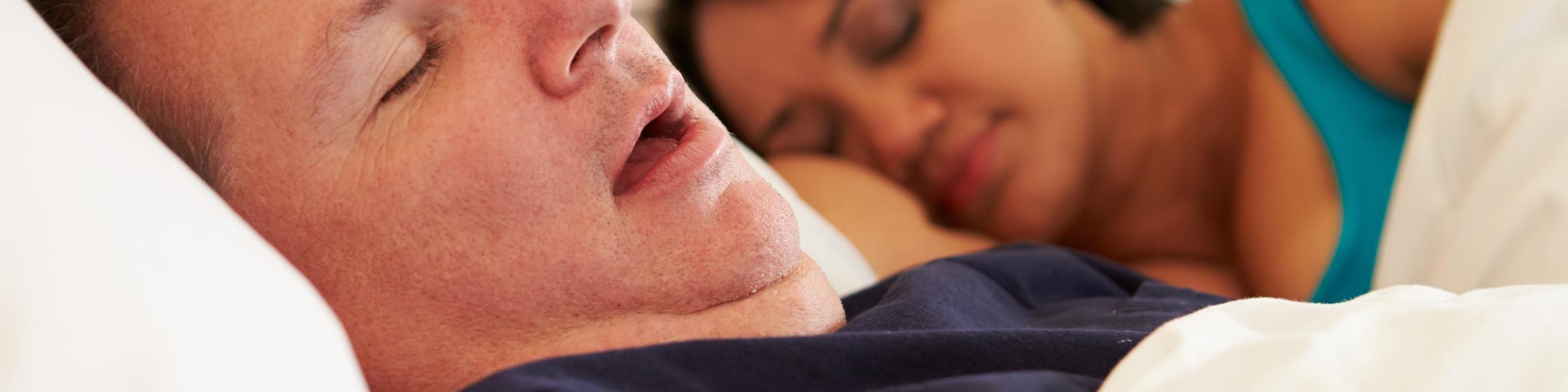couple asleep on the bed, man snoring