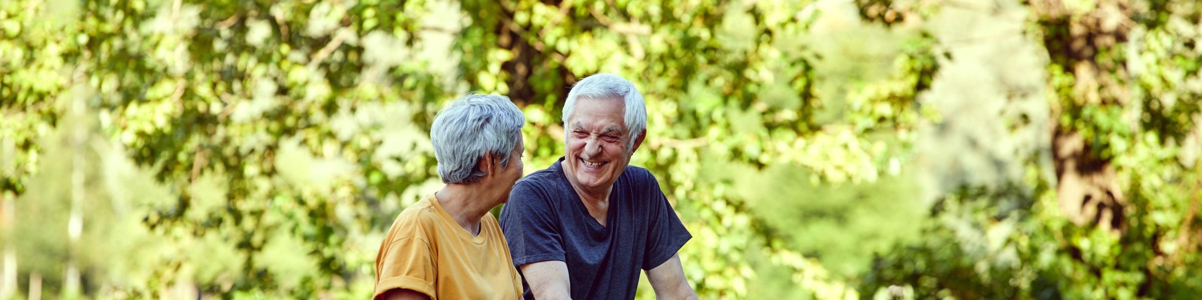 Older couple on a bridge in a park