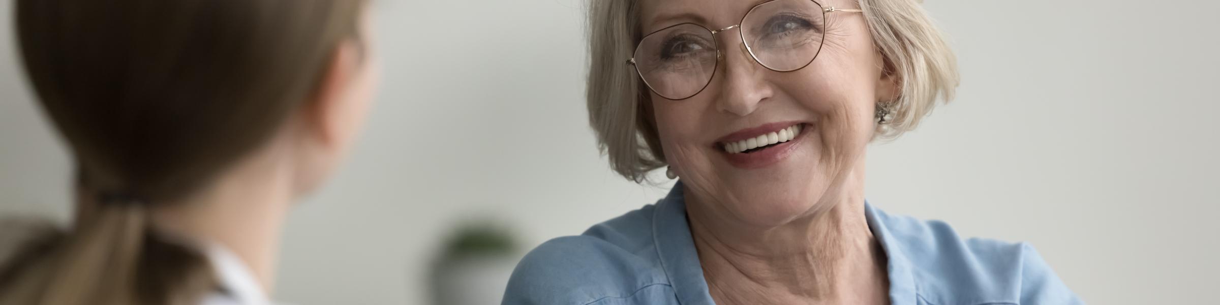 Older female patient talking to doctor