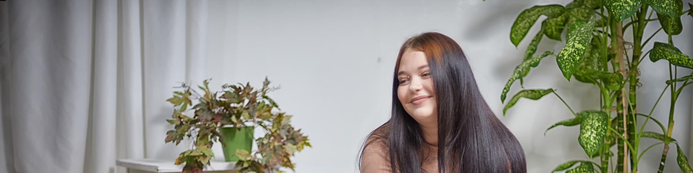 Stylish chubby female student with type 2 diabetes sitting on a bean bag